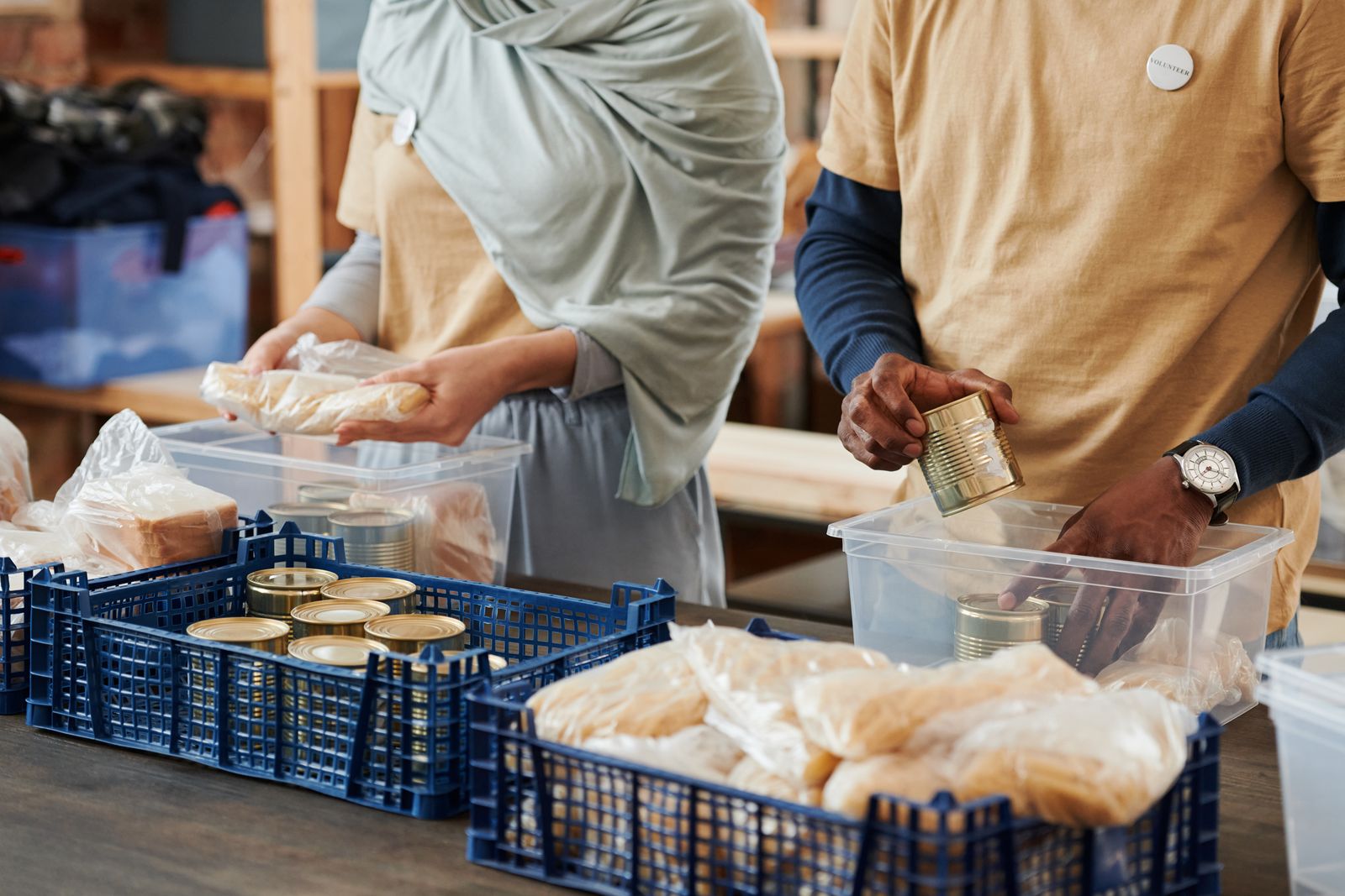 Volunteers packing food donations into crates Volunteers packing food donations into crates